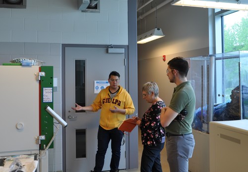 Eugene Enriquez giving a tour of the BDDC lab to Dianne Finstad