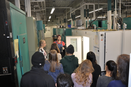 Group of high school students being given a tour of the growth facilities by Austin.