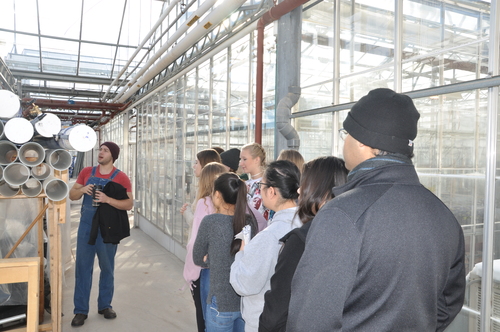 High school students being given a tour of the greenhouses by Austin Bruch.